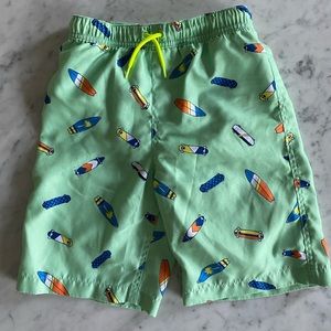 Boys swim trunks in green with skateboard print